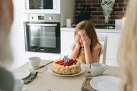 Girl in White Tank Top Eating Pizza