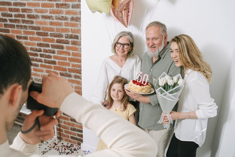 A Man Taking Photo Of A Family