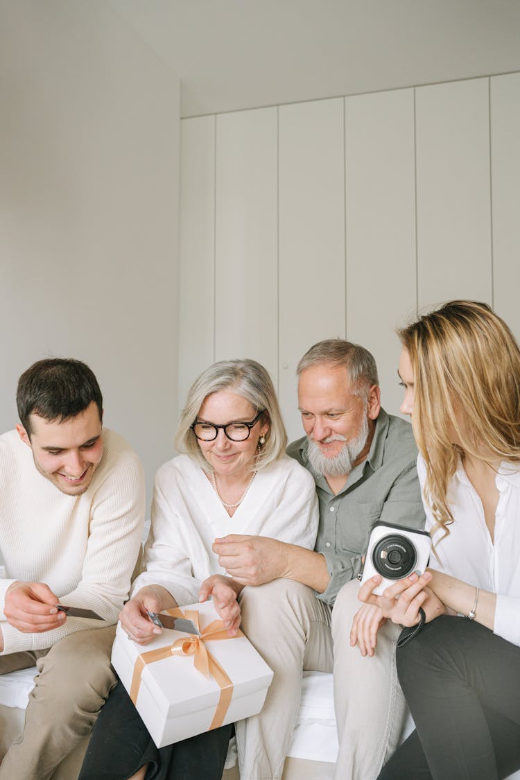 A Family Looking At A Polaroid Picture