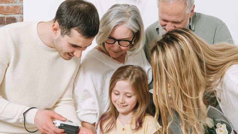 A joyful family moment with balloons and smiles captured indoors.