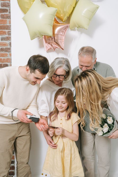 Free A joyful family moment with balloons and smiles captured indoors. Stock Photo