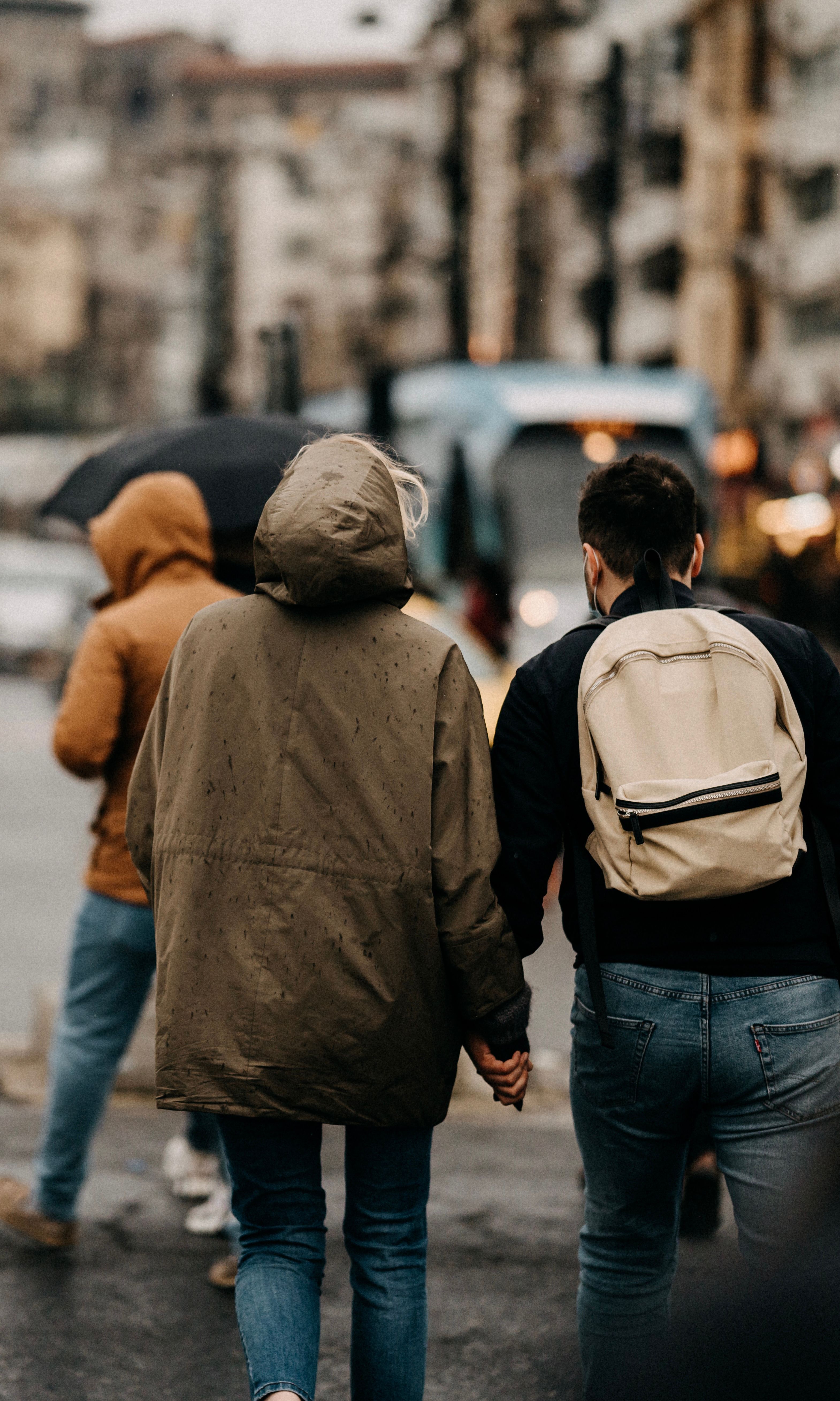 A Couple Holding Hands Walking on a Street · Free Stock Photo