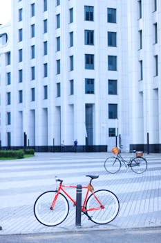 Bicycles parked in front of a modern white building in Moscow. Urban lifestyle scene.