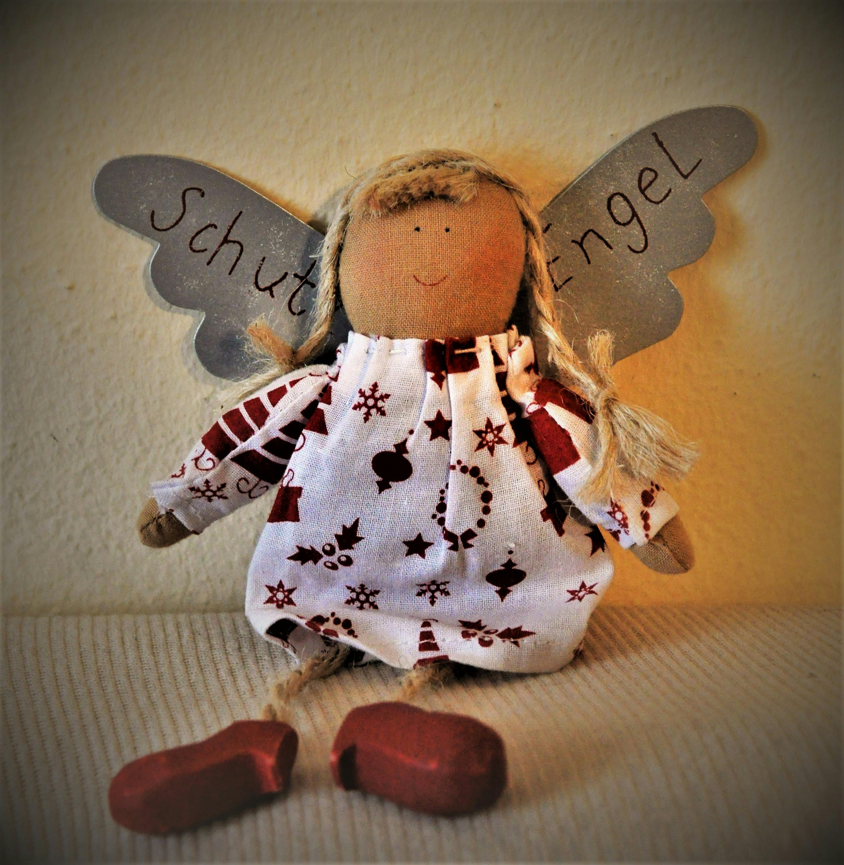 brown and white angel doll