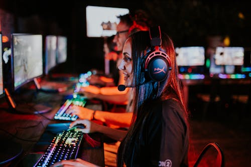 Woman and Man at Computers in Gaming Center