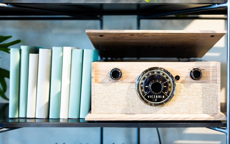 Shelf With Blue Notebooks And Wooden Box With Radio Buttons