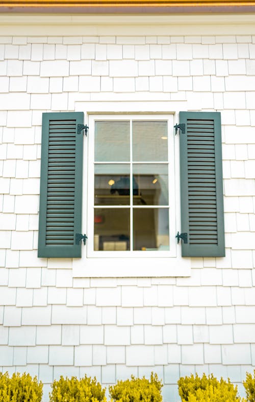 Free Wooden Shutter and Glass Window on a Brick Wall Stock Photo