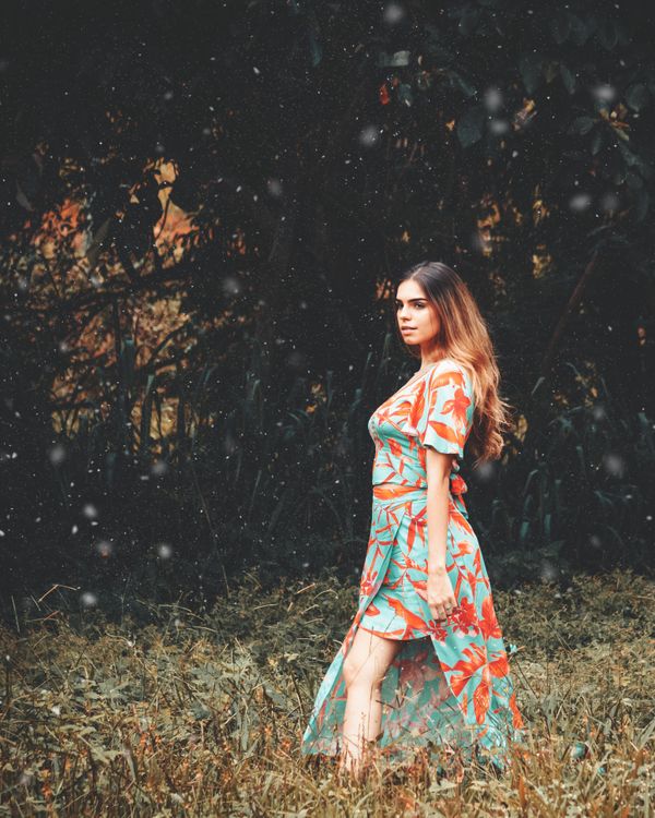 A Woman in a Floral Dress on a Grass · Free Stock Photo