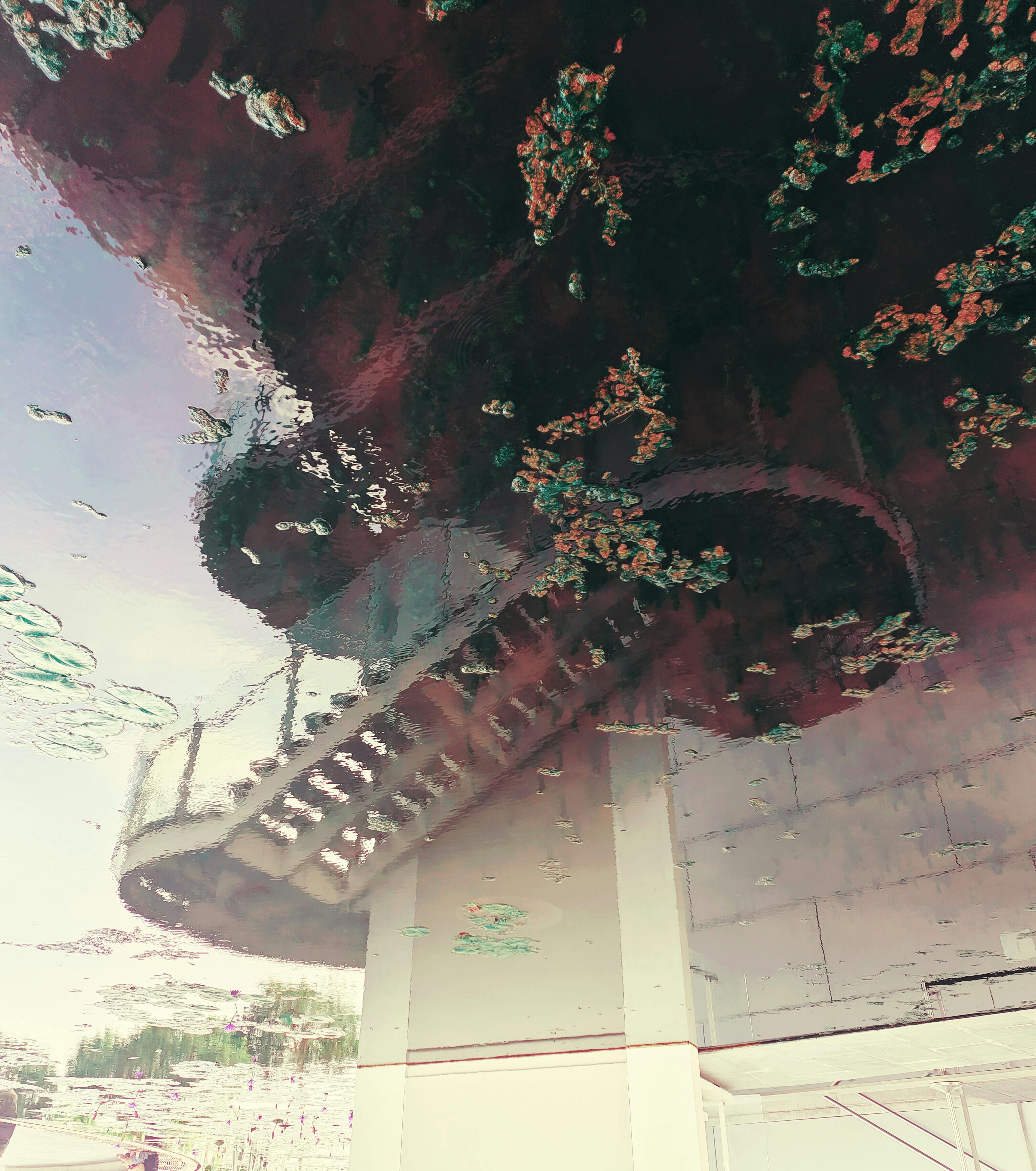 Blurred reflection of a staircase in water, creating an abstract, dreamlike effect.