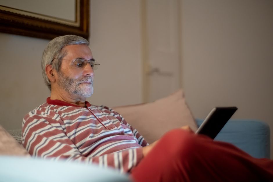 Senior using a tablet to stay connected with family - senior lifestyle management Senior using a tablet to stay connected with family - senior lifestyle management