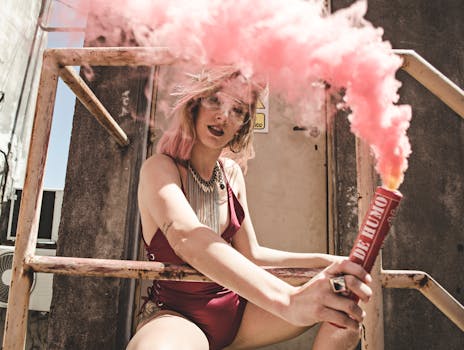 Woman in Maroon Monokini Holding Dynamite