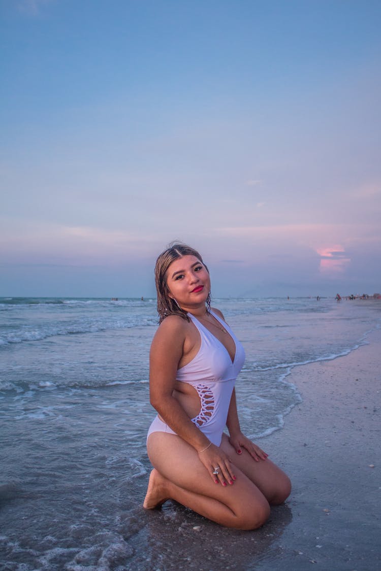 Woman Posing In A White Swimsuit On A Beach