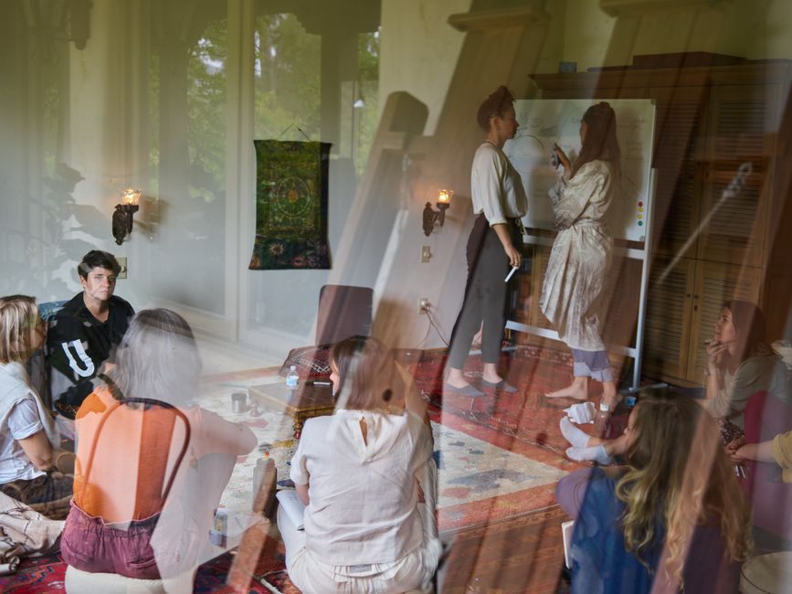 A diverse group of adults engaged in a workshop discussion