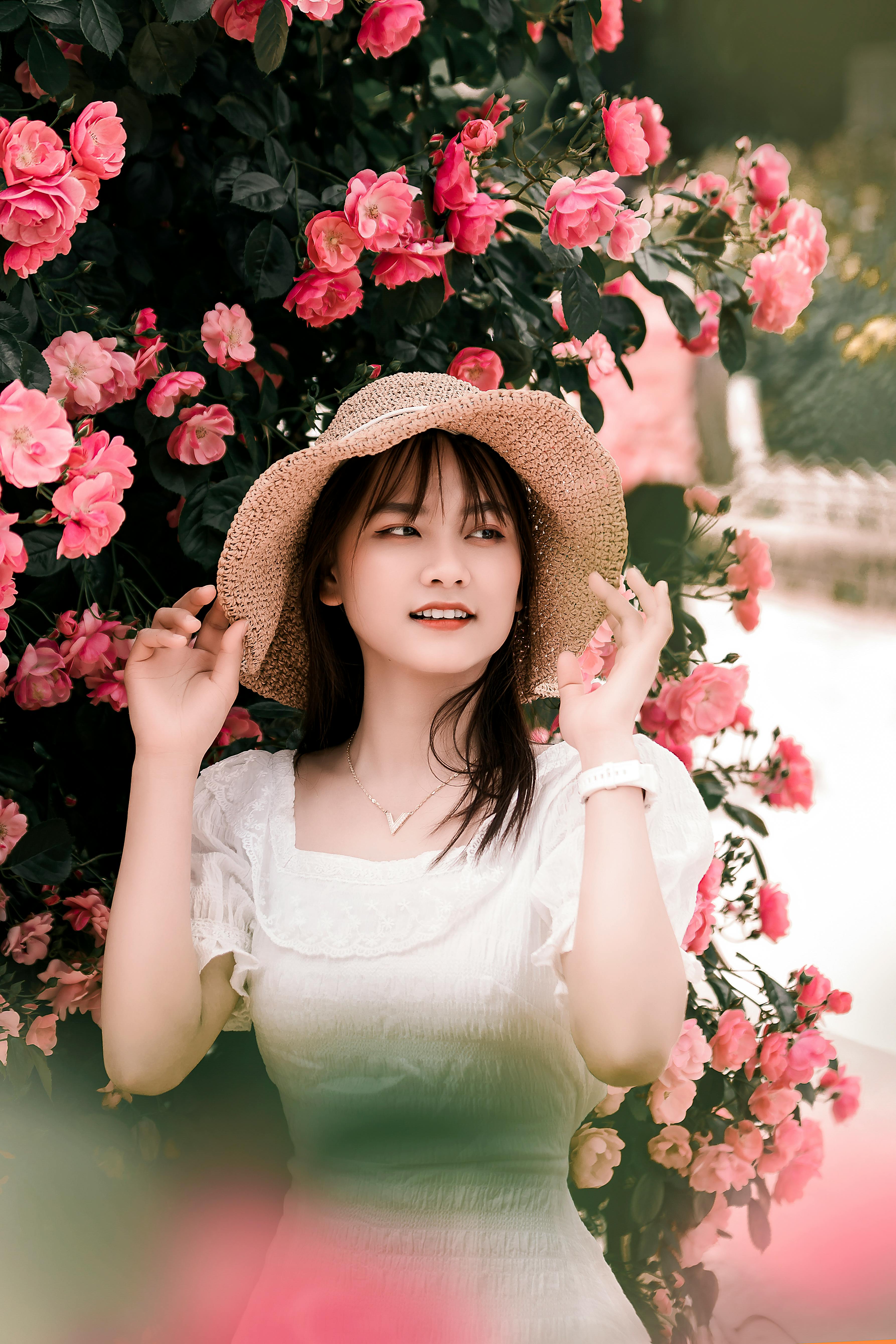 Photo of a Woman in a Red Dress Holding Red Flowers · Free Stock Photo