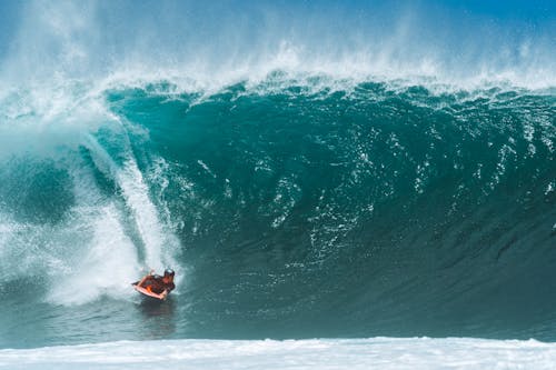 Man riding surfboard on stormy sea