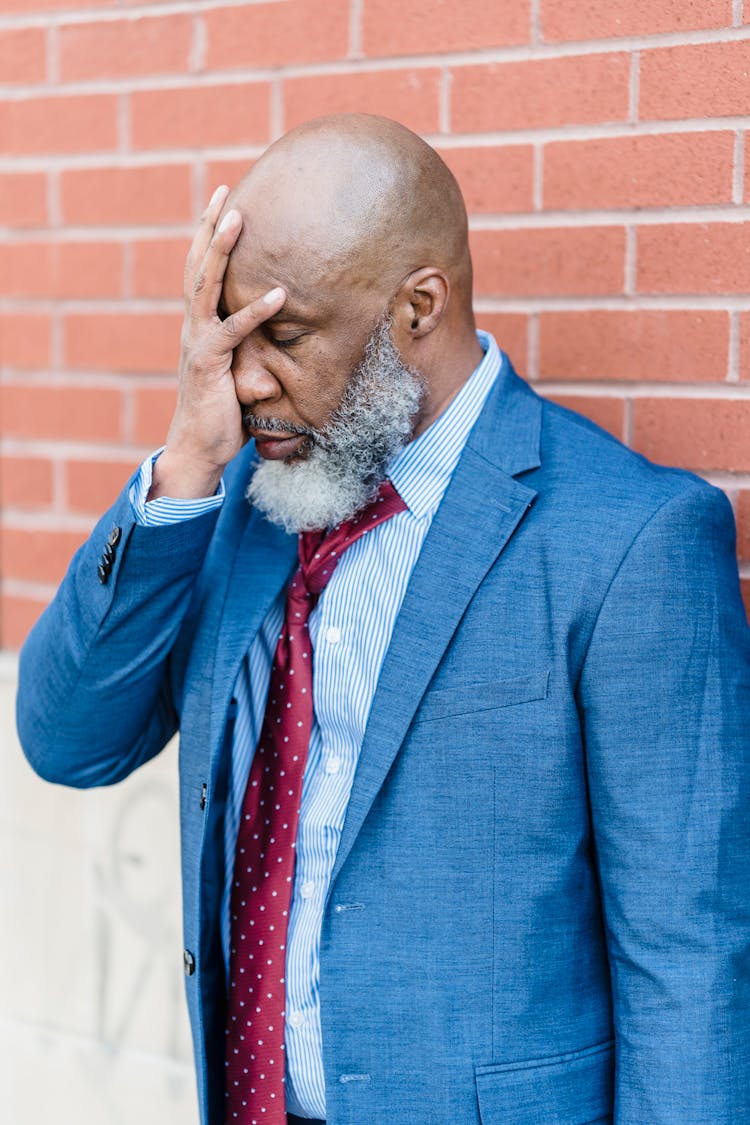 Depressed Black Businessman On Street