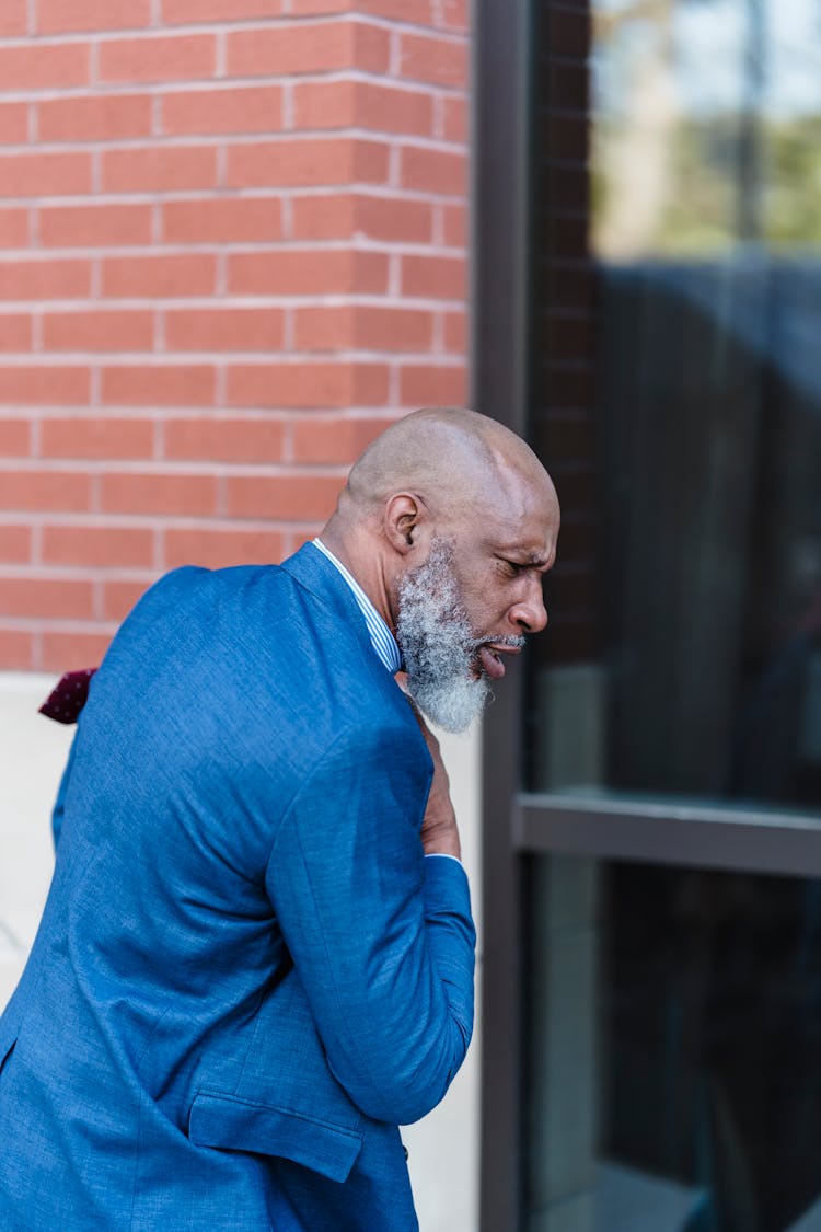 Concerned Black Businessman Walking On Street