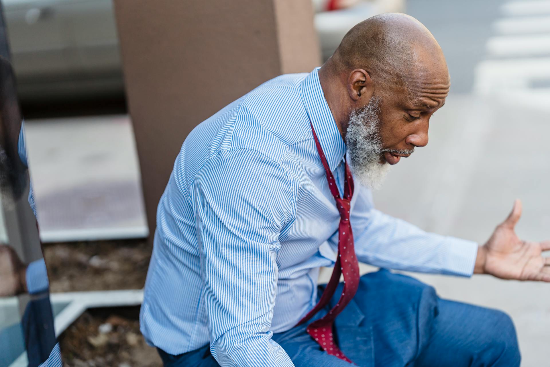 Frustrated black businessman on street