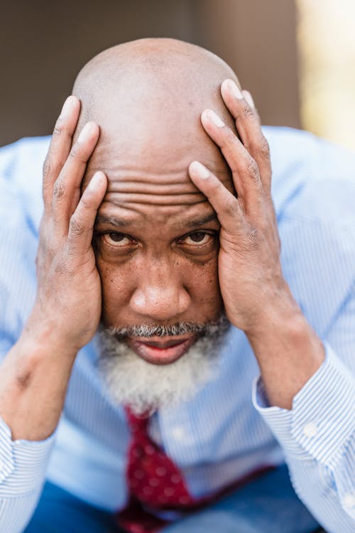 A Man Holding His Head