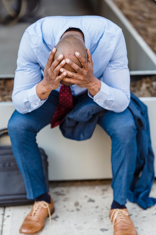 Free Upset faceless black businessman on street Stock Photo