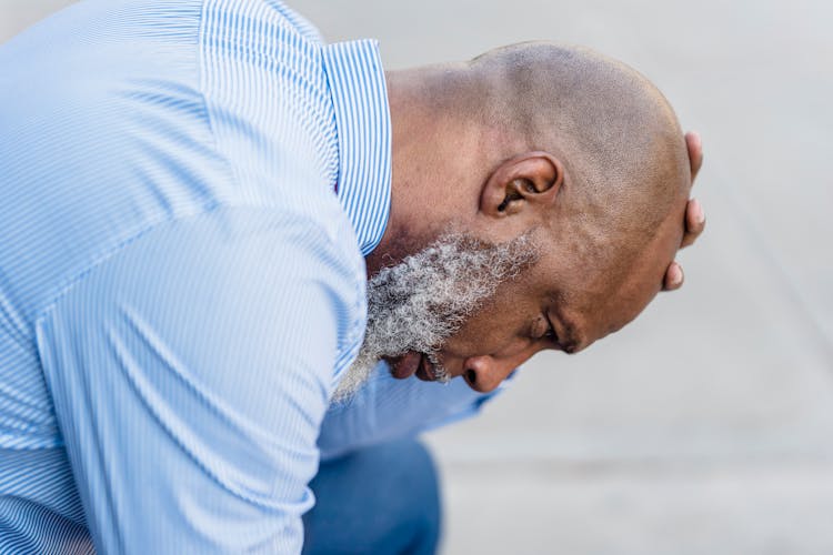 Depressed Black Businessman On Street