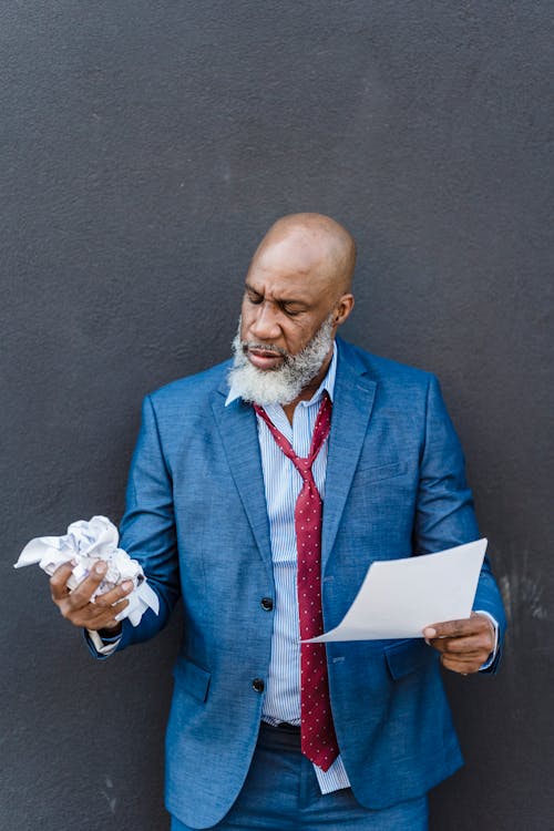 Free Serious black businessman with documents Stock Photo