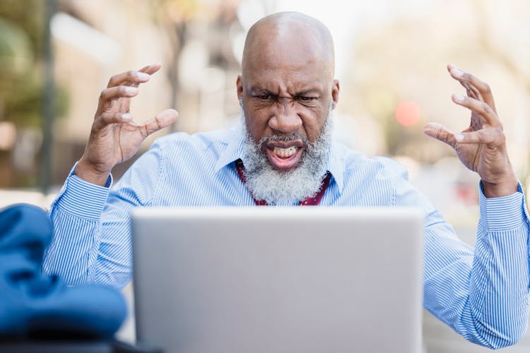 Angry Black Man Having Video Conversation Via Laptop