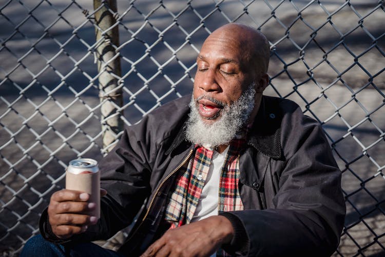 African American Homeless Man Holding Beer On Street