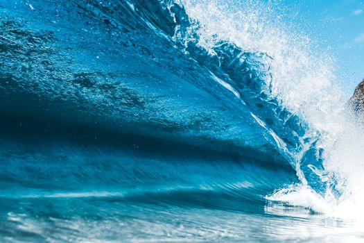 Splashing turquoise wave rolling on sea