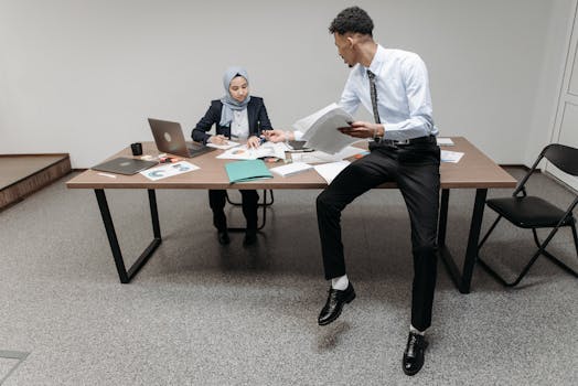 A diverse team discussing documents and strategies at a modern office table indoors.