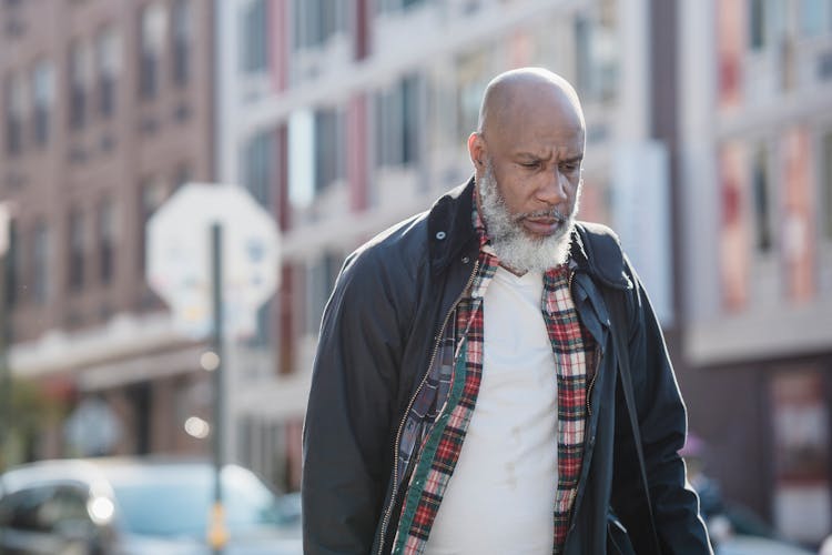 Old Man In Outerwear Walking City Street