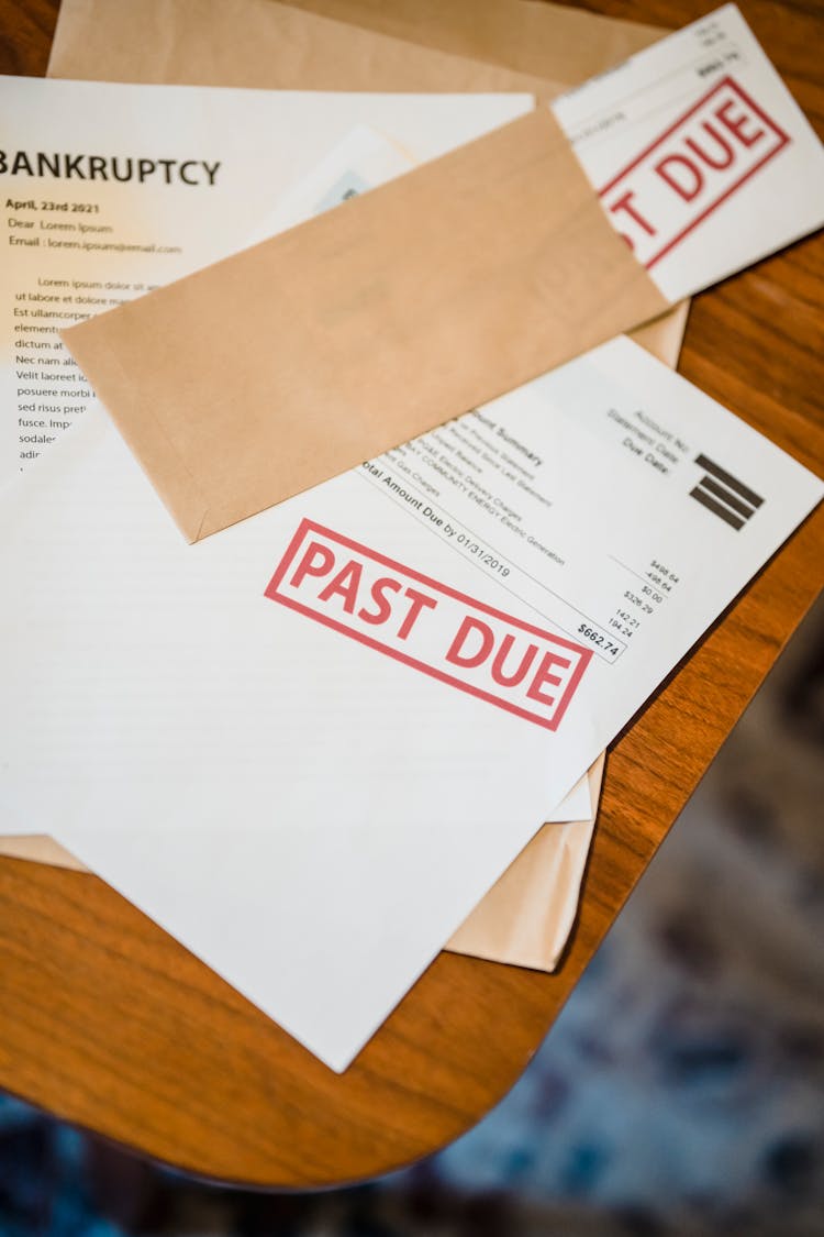 Past Due And Bankruptcy Papers On Table