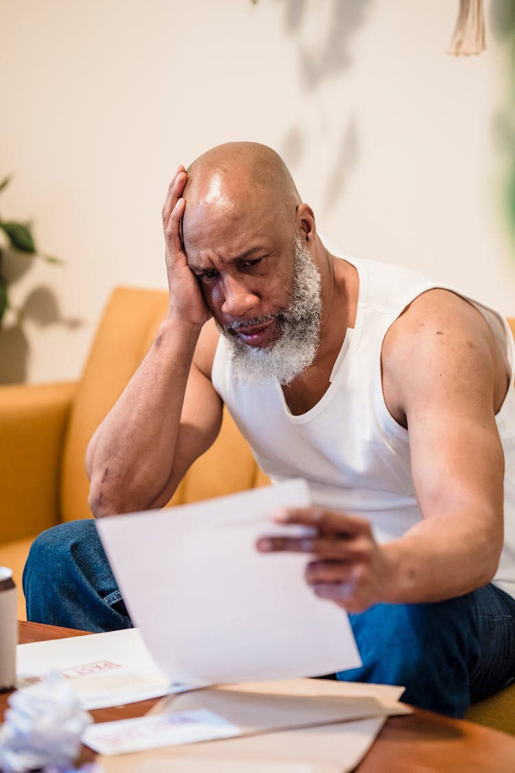 Terrified Man Looking At Papers