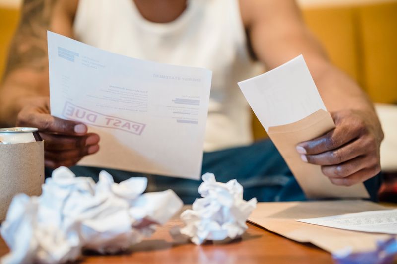 Paper receipts and invoices on a desk — photo by Nicola Barts on Pexels