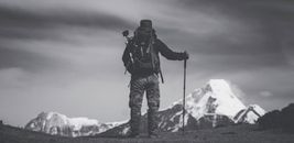 Grayscale Photo of Man Standing on Ground