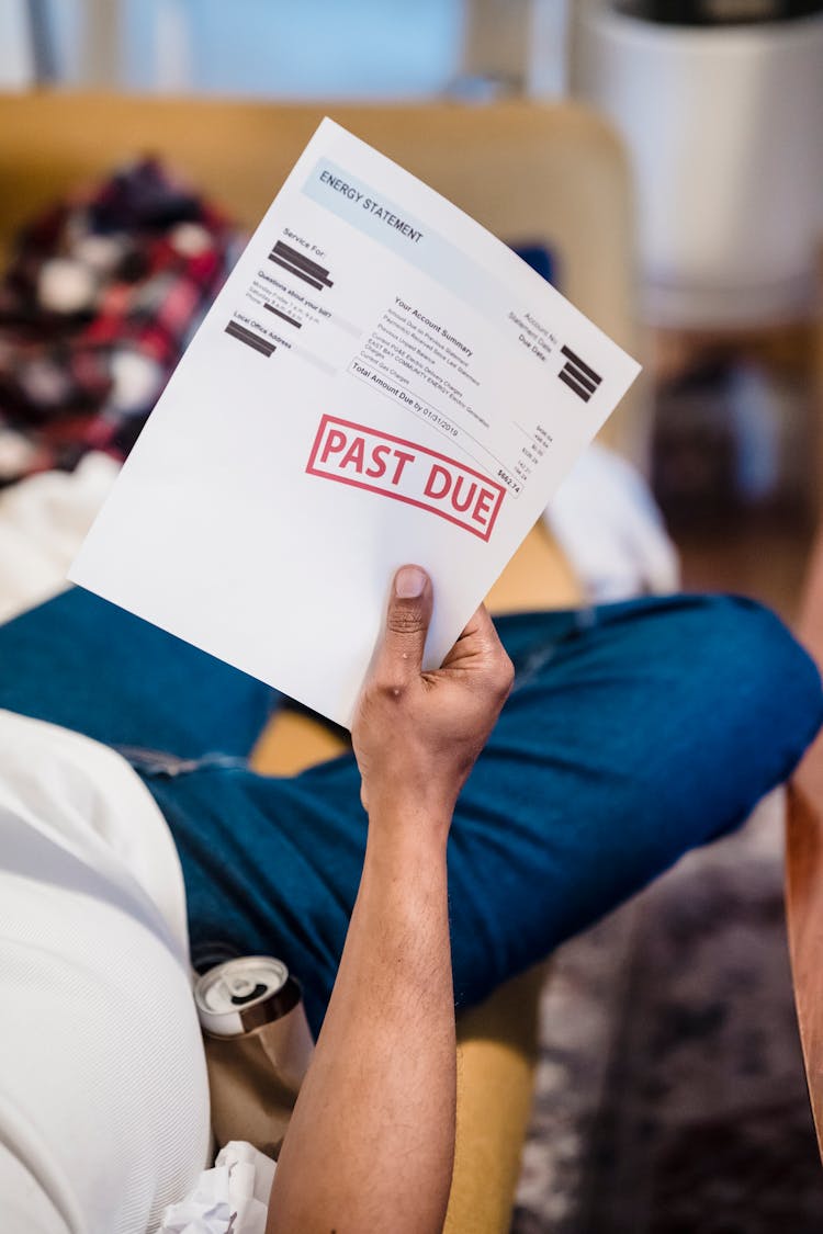 Man Holding Past Due Billing Statement