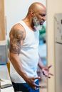 Man in White Tank Top and Blue Shorts
