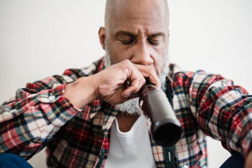 Close Up Photo of Man Drinking Beer