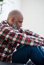 Man in Red White and Black Plaid Dress Shirt Sitting on Blue Chair