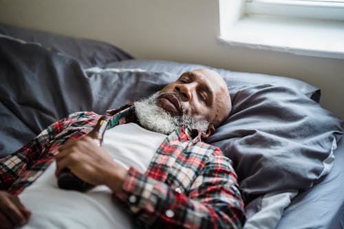 Close-up Photo of Man sleeping on his Bed 