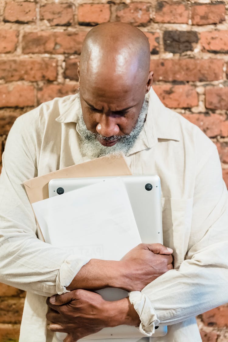 Old Man With Papers And Laptop