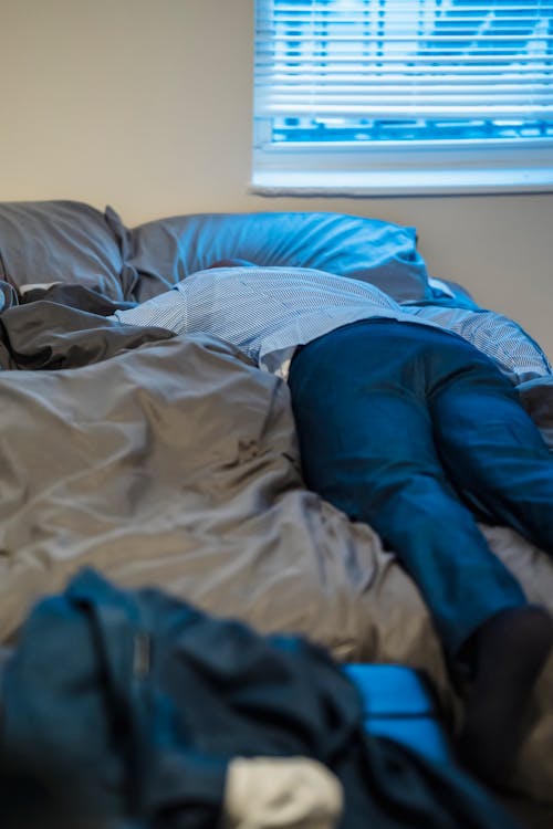 Free Person Lying on Bed Stock Photo