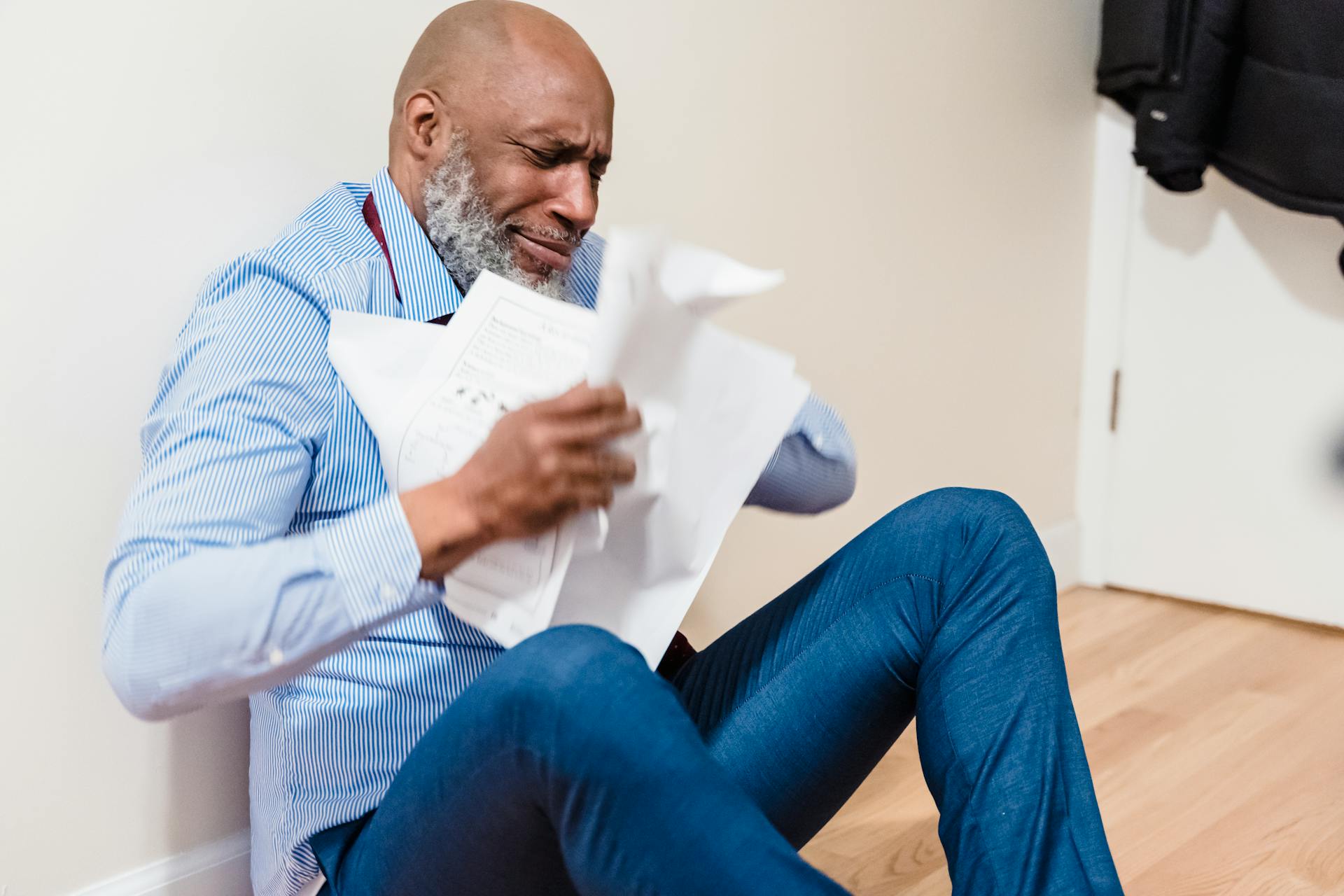 Stressed Old Man Throwing Paperwork at Home