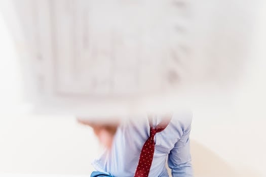 Close-up of a professional in motion, creating a blurred dynamic office scene.