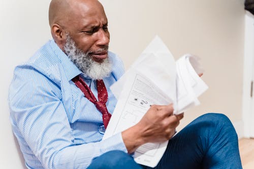 A Man Sitting with Documents