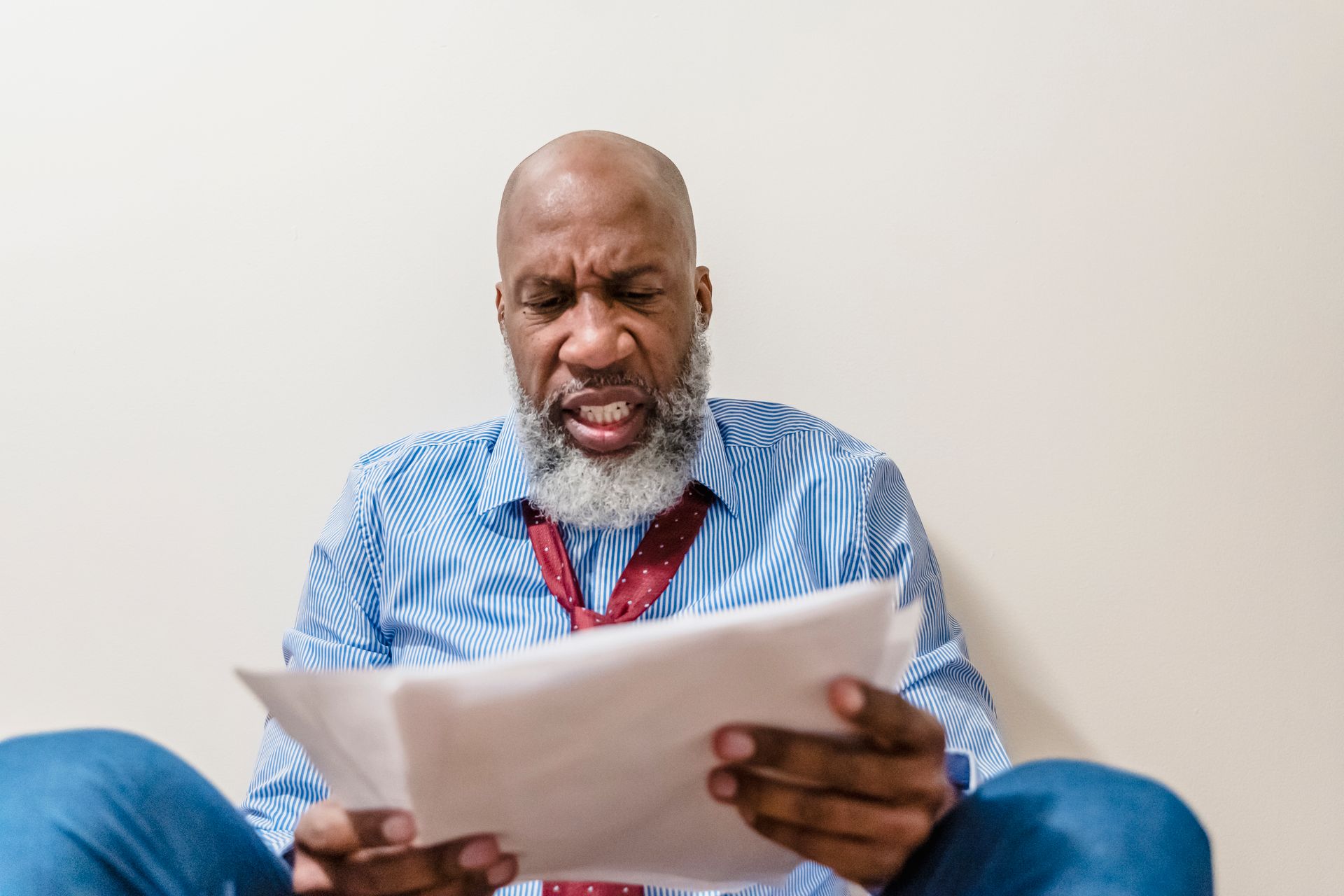 Bald Man Holding Documents