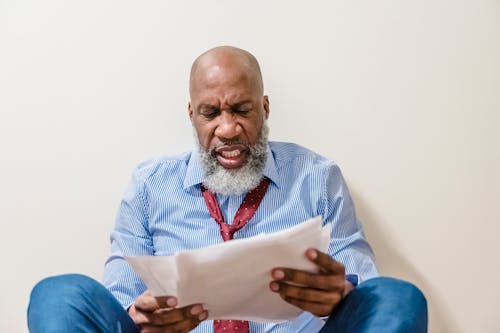 Free Bald Person Holding Papers Stock Photo