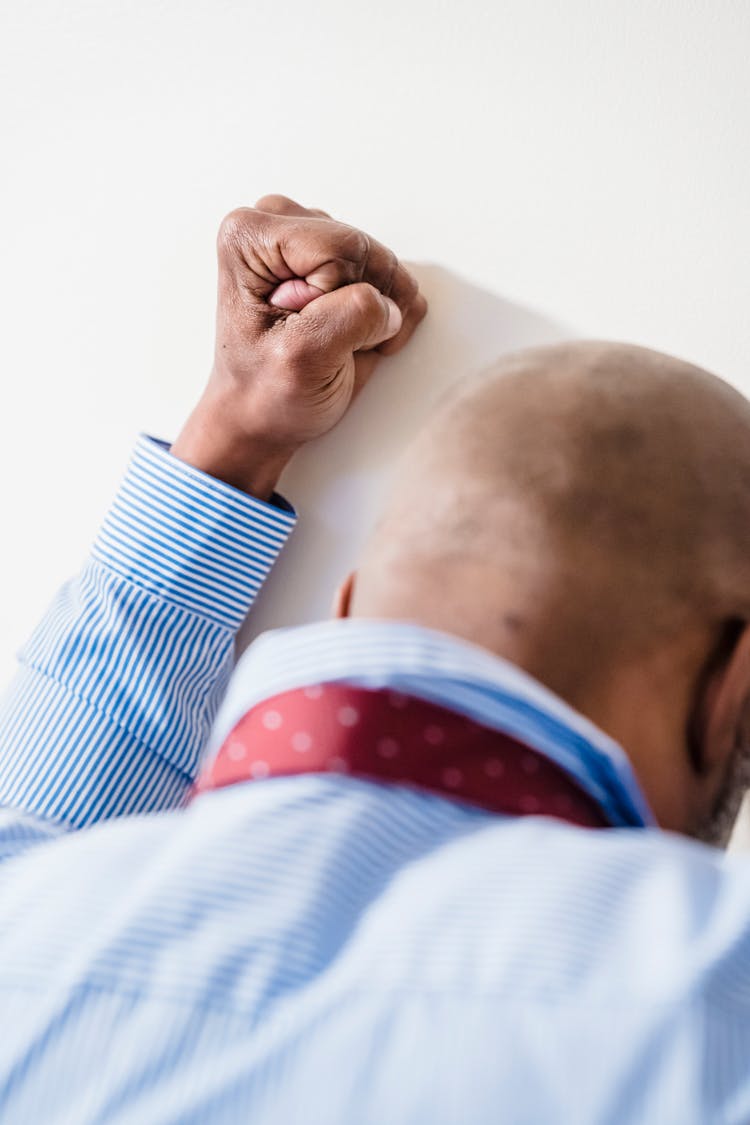 A Man Punching A Wall