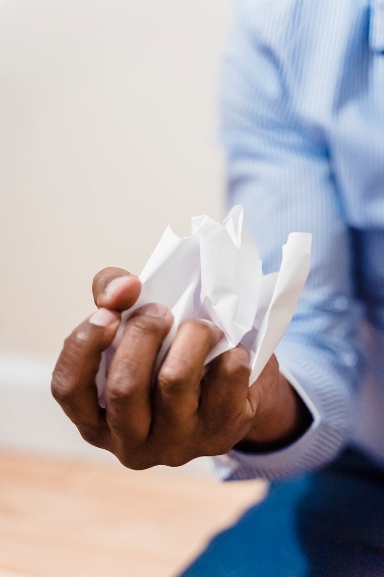 Close Up Shot Of A Person Crumpling A Paper