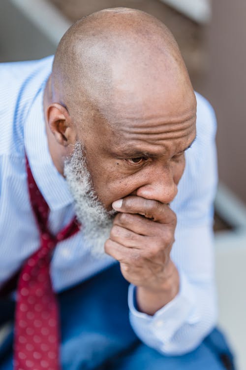 Close Up Photo of a Bald Man